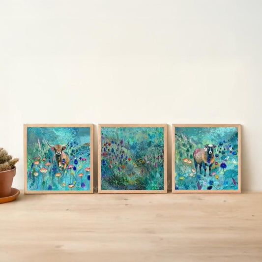 three framed paintings of cows in a field, each with a different color scheme and style.
