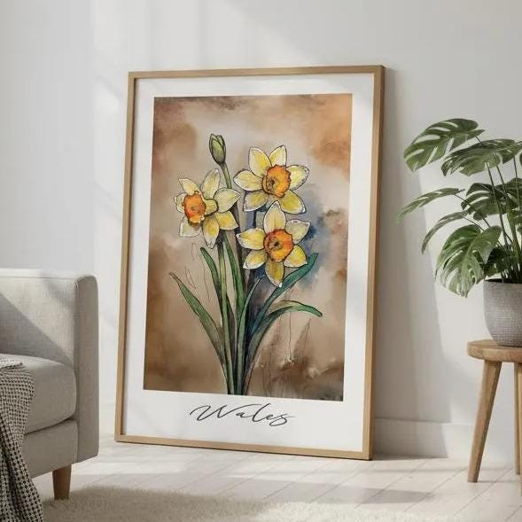 a living room with a gray sofa, a large framed painting of yellow daffodils, a potted plant, and a rug on the floor.